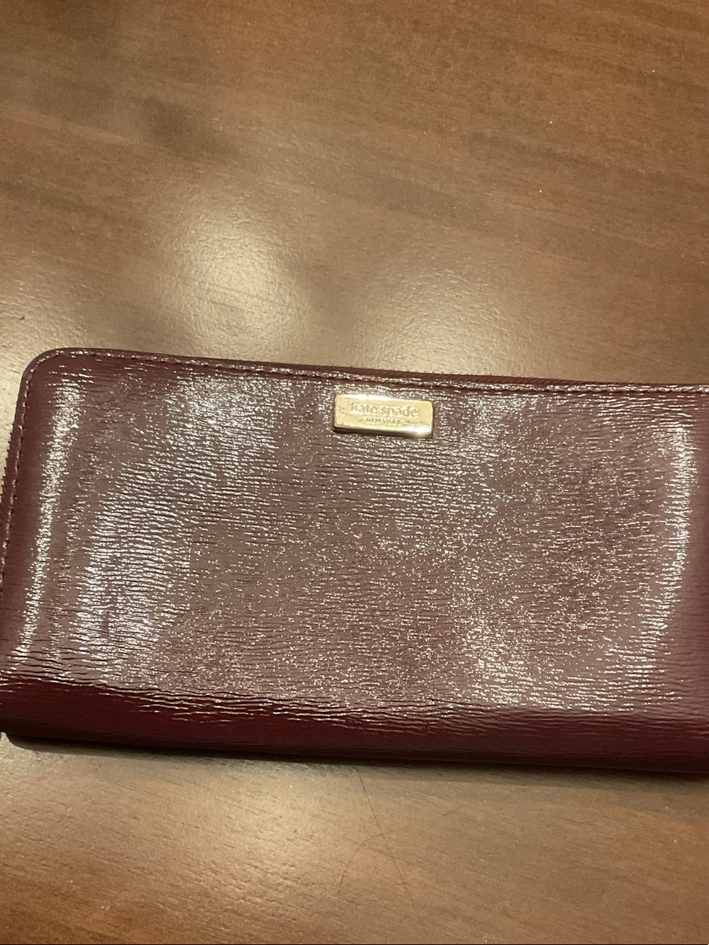 kate spade Patent Burgundy Zip-Around Wallet with Gold Logo Plaque